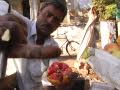Indian fruit seller shows off a pomegranate