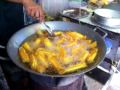A turon vendor demonstrates how to cook turon