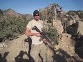slightly modified m4 to shoot fully auto instead of 3 shot burst, obviously with a suppressor (surefire fa556) random mountain top, eastern afghanistan.