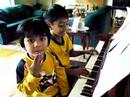 Spencer & Bradley playing piano.