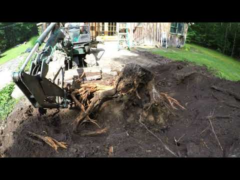 Digging out stumps with a mini excavator
