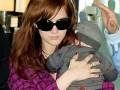 Ashlee Simpson-Wentz and baby Bronx Mowgli in airport 3/4/09