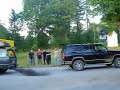 Rednecks playing tug of war with two trucks