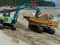 Redistributing sand on beach at Miyajima, Japan Redistributing sand on beach at Miyajima, Japan