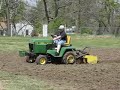 Grandson and JD 318 tiller working new ground