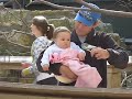 Dad and Emily Feeding a Bird at the Zoo