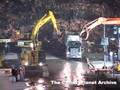 Bulldozers at ground zero putting wreckage into dump trucks