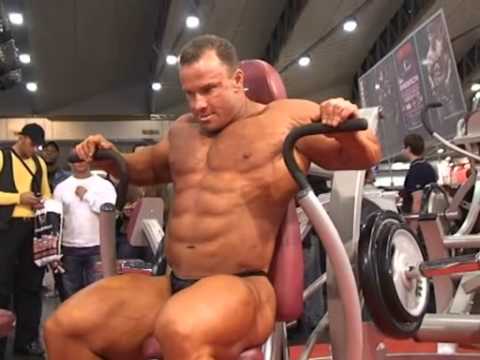 Rockel - Huge Ronny Rockel pumps up in just a tiny pair of posing trunks in front of an appreciative audience.