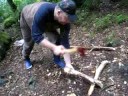 cutting wood with little axe,,, in a rainy day,
