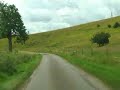 Drive through WOODNOOK, nr. Grantham, Lincolnshire.August 27th 2007.Woodnook Valley in South Kesteven, Lincolnshire, U.K., is a small hidden calcareous grassland, and a Site of Special Scientific Interest.Camcorder: JVC GR-D270EK,Edited in Ulead VideoStudio 11.Uploaded as a Zune Mpeg4 640x480 file. This is an offshoot YouTube page of VideoPostcards, and will largely cover the same geographical locations as that site, namely:Barrowby, Denton, Little Ponton, Antons Gowt nr. Boston, Crowland, Wimbledon, Wimbledon Common, London, London Eye, Albert Bridge, Belvoir Castle, Harlaxton, Harlaxton Manor, Hemmingford Abbots, Belton nr. Grantham, Grantham market place, Woolsthorpe by Belvoir, Londonthorpe, Londonthorpe Wood, Honington, Epping Forest, Woodnook Valley, Walcot nr. Folkingham and Sleaford, Stoke Rochford, Stroxton, Harlow, Peakirk, Clipsham, Knipton, Harston, Casthorpe, Billingborough, Horbling, Little Humby, Little Bytham, Castle Bytham, Wainfleet, Threekingham, Folkingham, Sedgebrook, Helpringham, Heckington, Sleaford, Woodnook, Old Somerby and Rospley.
