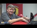 leif and the guys from car bench put the ferrari on the rack. then, leif removes the front bumper and the dash.
