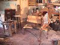 sculptor sculpting a human-sized copper frog sculptor sculpting a human-sized copper frog