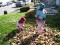 Estelle 14 mois essaie de sauter dans les feuilles, sa soeur Dorianne 4 ans lui montre