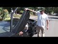 a fat guy squeezes out of a lamborghini style car during the summer of 69