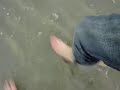 two girls feet in sea