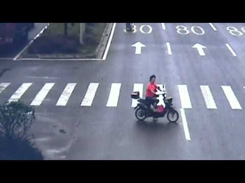 Lucky escape: Woman uninjured after truck crushes scooter in China