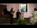 kathryn & molly green are accompanied on the guitar by their father, robert green, in 