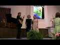kathryn & molly green are accompanied on the guitar by their father, robert green, in 