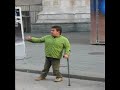 Giocoliere palleggia con pallone e stampelle a Milano Giocoliere palleggia con pallone e stampelle a Milano