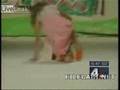 Models falls over twice - anchor man can't stop laughing