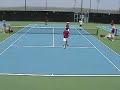 Net player takes a big hit in a D-2 college doubles tennis match