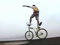 Crazy balancing bike rider on roof of building