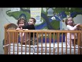 Laila, Gideon and Geneva bouncing in a crib