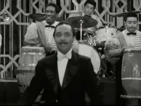 mambo - from the 1956 movie cha cha cha boom...my father is the congero on the right....behind perez prado.