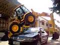 Car passing under the JCB 4CX backhoe loader