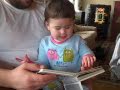 Lily looks thru a book.