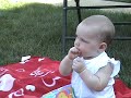 Addison Teini eating a treat from Kendall her cousin.  She really liked the cheese puff and is looking forward to more.