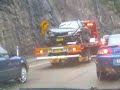 Car being towed with windscreen wipers still going