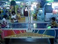 playing air hockey at Tunjungan Plaza Surabaya, Indonesia