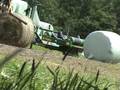 New Holland baling and wrapping round bale haylage