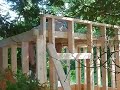 up on the roof of a sauna in construction, which jay rayner is building single-handedly, he ignores silly cameraman and canine observer and gets on with the job.  what a guy!