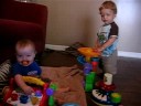 george lovin preston's toys, and preston having fun just watching.