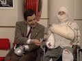 OFFICIAL MR BEAN. Having trapped his hand in a teapot, Mr Bean arrives at the hospital in his mini and blocks an ambulance in. He has a fight with a lady in bandages as he tries to jump the queue to be seen first. From the 13th Mr Bean programme 'Goodnight Mr Bean'.