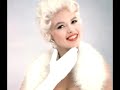 Here is a famous song performed by the delicious and extravagant Jayne Mansfield.Jayne Mansfield (born Vera Jayne Palmer in 1933, Bryn Mawr, Pennsylvania - d. 1967) was an American actress and sex symbol. Famed for her platinum-blond hair and voluptuous figure, she emerged during the 1950's appetite for glamorous sex symbols led by Marilyn Monroe. In February 1955, Mansfield was the Playmate of the Month in Playboy, for which she would pose several more times over the ensuing years. In April of 1957, Jayne pulled off one of the most notorious publicity acts in history by upstaging Sophia Loren during a party in Loren's honor. Mansfield, having already upstaged Jane Russell at a premiere party by coming out of a swimming pool topless a few years earlier, pulled off a similar stunt with Sophia Loren by literally pulling out her breasts at the table Loren was seated at. Russ Meyer said that Jayne's reputation for being large breasted was a false one and that it was due mainly to her large ribcage and tireless attention getting schemes that had the press continually fixated on her chest. Mansfield was unable to upstage Anita Ekberg who had the largest natural breasts in Hollywood history. It is said that upon seeing Anita Ekberg in person Jayne got back into her car and drove away! Mansfield won a Golden Globe in 1957 for Most Promising Newcomer - Female, beating out Carroll Baker and Natalie Wood. Although her flamboyant persona made her tough to cast, she was widely considered Marilyn Monroe's number one rival in a crowded field of contenders that included Mamie Van Doren, Diana Dors, and some others. Mansfield was also a singer and headlined in Las Vegas. In 1963 she released her now cult record 