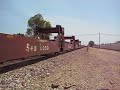 BNSF C40-8W #909 leads S/B bartables with it\