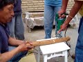 Making holes in a log to shiitake cultivation