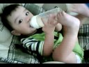 Andrew holding bottle with his feet