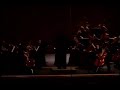 the broken arrow high school orchestra plays a classic song for contest and endures an overheated light show, causing the stage to go black numerous times. notice how the music continues without flaw, even as the lights become a major disctraction.