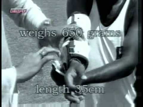 Murali bowling with an arm brace