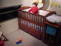 at 1 yr & 7 months ethan goes 3 for 3 in hitting a target the size of a belt buckle from his baby bed & then celebrates with a happy dance