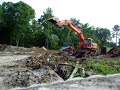 Excavator and skid steer build a pond dam Excavator and skid steer build a pond dam