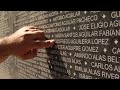 Pointing to his cousin on the memorial wall