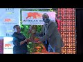 AWF CEO Kaddu Sebunya presenting the Bejamin Mkapa Photography Awards statue to Madam Mkapa