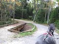 Harness horses encounter double bridge on dirt road