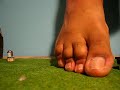 Giant male feet terrorize a city