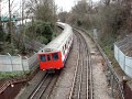 District line tube train along track near North Ealing